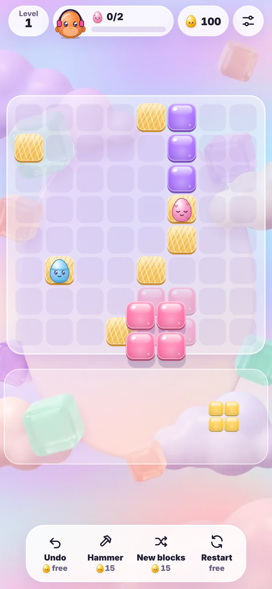 A pink 2x2 block being placed below the pink egg while a yellow 2x2 block waits in the tray
