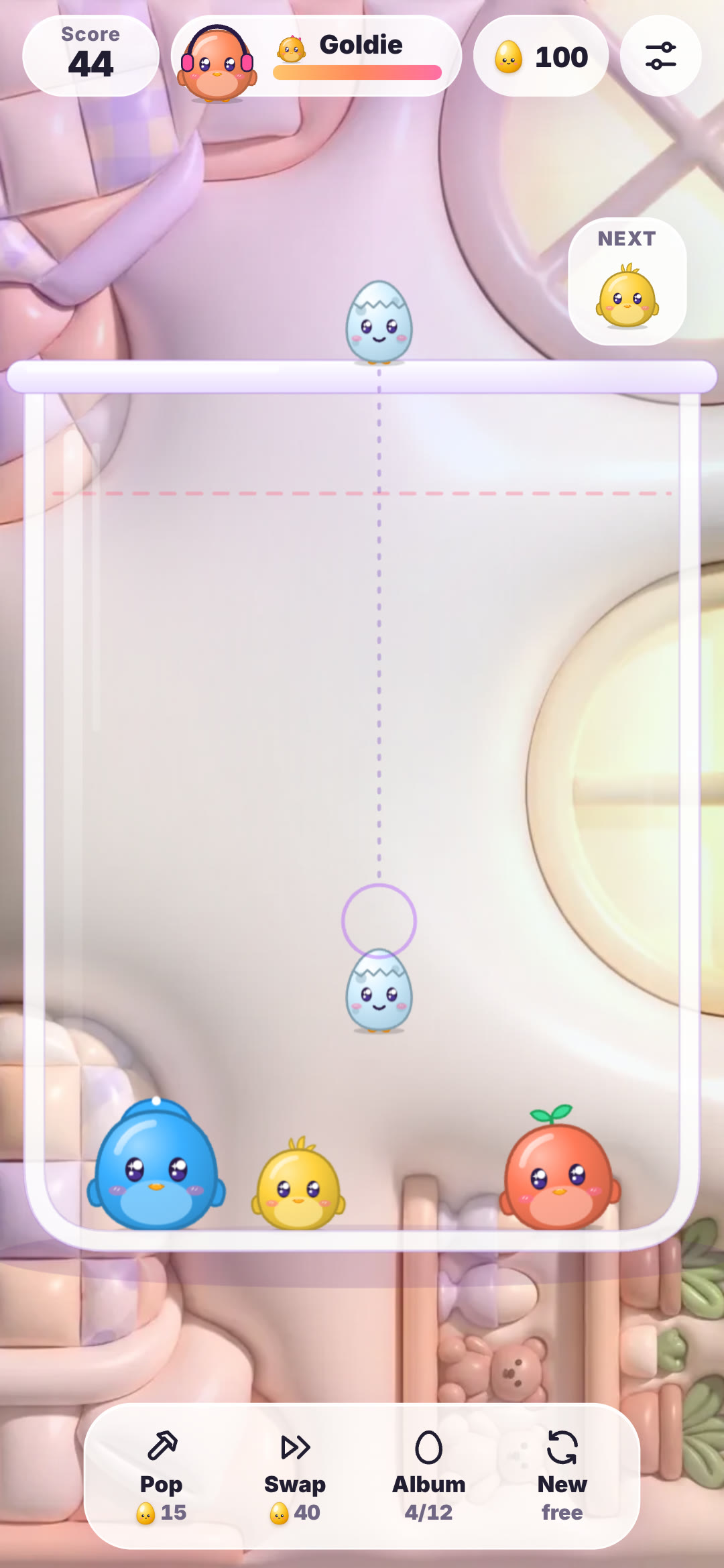 Egg Drop on a phone: blue, yellow and red OvOs resting in the glass jar with the next egg aimed from the top